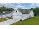 White two-car garage with gray roof, landscaping and a paved driveway at 3719 Tielman St, Snellville, GA 30078