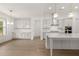Open concept kitchen with white cabinets and hardwood floors at 3719 Tielman St, Snellville, GA 30078