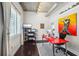 Bright home office features a red desk, large window, and hardwood floors at 206 11Th Ne St # 703, Atlanta, GA 30309