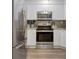 Modern kitchen with stainless steel appliances and white cabinets at 2870 Pharr Court South # 503, Atlanta, GA 30305