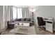 Cozy living room with gray sectional sofa and white coffee table at 2870 Pharr Court South # 503, Atlanta, GA 30305