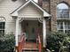Small front porch with wooden railing and light blue chairs at 2520 Conley Dr, Cumming, GA 30040