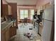 Kitchen with wood cabinets, vinyl flooring, and a white refrigerator at 2520 Conley Dr, Cumming, GA 30040