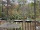 Deck with table and chairs overlooking wooded area at 2520 Conley Dr, Cumming, GA 30040