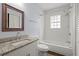 Updated bathroom with granite countertop, bathtub, and shower at 1686 Alvarado Sw Ter, Atlanta, GA 30310