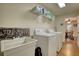 Convenient laundry room with washer, dryer, utility sink, and shelving at 3030 Habersham Cir, Covington, GA 30014