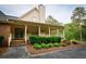 Brick and siding house with wrap-around porch and landscaping at 3030 Habersham Cir, Covington, GA 30014