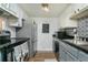 Galley kitchen with gray cabinets and black countertops at 3103 Reeves Se St, Smyrna, GA 30080