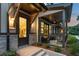 Townhome entrance with covered porch, stone accents, and welcoming lighting at 925 Willingham Dr # 13, Hapeville, GA 30354