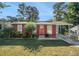 Charming brick ranch home with a red door and landscaped yard at 2648 Santa Monica Nw Dr, Atlanta, GA 30318