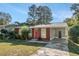 Cute brick ranch house with a red door, and a grassy yard at 2648 Santa Monica Nw Dr, Atlanta, GA 30318