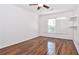 Second bedroom with hardwood floors, window with shutters and wall shelving at 260 Manning Sw Rd # 127, Marietta, GA 30064