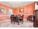 Elegant dining room with coral walls, a chandelier, and a large wooden table at 5013 Kendall Nw Sta, Acworth, GA 30102