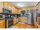 Kitchen with stainless steel appliances and light wood cabinets at 2902 Creekstone Dr, Acworth, GA 30102