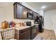 Kitchen with dark brown cabinets, granite countertops, black appliances, and copper accents at 51 Pulaski Ave, Hampton, GA 30228