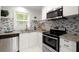 Modern kitchen with stainless steel appliances and granite countertops at 3018 Wanda Sw Cir, Atlanta, GA 30315
