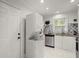 White kitchen cabinets, stainless steel appliances, and granite countertops at 3018 Wanda Sw Cir, Atlanta, GA 30315