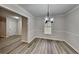 Bright dining room with new flooring and a modern light fixture at 245 Southmoor Cir, Stockbridge, GA 30281