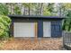 Detached garage with white door and brick base at 1790 Ledo Ave, Decatur, GA 30035