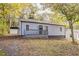 House exterior showcasing gray siding, a deck, and a detached garage at 1790 Ledo Ave, Decatur, GA 30035