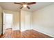 Hardwood floor bedroom with ceiling fan and access to bathroom at 1790 Ledo Ave, Decatur, GA 30035