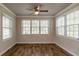Bright sunroom with multiple windows, wood flooring, and a ceiling fan at 1790 Ledo Ave, Decatur, GA 30035