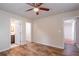Bedroom with hardwood floors, ceiling fan, and access to bathroom and hallway at 1790 Ledo Ave, Decatur, GA 30035