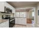 Updated kitchen with white cabinets, granite countertops, and stainless steel appliances at 1790 Ledo Ave, Decatur, GA 30035