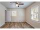 Bedroom with hardwood floors, ceiling fan, and two windows at 1790 Ledo Ave, Decatur, GA 30035