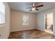Bedroom with hardwood floors, ceiling fan, and bathroom access at 1790 Ledo Ave, Decatur, GA 30035