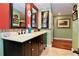 Double vanity bathroom with dark wood cabinets and red accent wall at 8710 Mount Rushmore Dr, Alpharetta, GA 30022