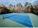 Two well-maintained tennis courts with surrounding trees at 8710 Mount Rushmore Dr, Alpharetta, GA 30022