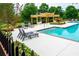 Community pool with pergola, lounge chairs, and steps at 2357 Bayrose Cir # 57B, East Point, GA 30344