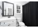 Clean bathroom with white vanity, black accents, and a shower/tub combo at 114 Arborwood Way, Temple, GA 30179