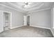 Large main bedroom with plush carpeting and tray ceiling at 114 Arborwood Way, Temple, GA 30179