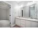 Double vanity bathroom with white cabinets and a large mirror at 114 Arborwood Way, Temple, GA 30179