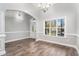 Elegant dining room with hardwood floors, crown molding, and a chandelier at 114 Arborwood Way, Temple, GA 30179