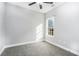 Bright bedroom with grey carpet and a large window, showcasing natural light at 114 Arborwood Way, Temple, GA 30179