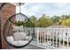 Relaxing balcony with a hanging chair, offering a wooded view at 1395 Orchard Park Dr, Tucker, GA 30083