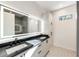 Modern bathroom featuring a double vanity, backlit mirror, and hexagon tile floor at 247 Huntington Ne Rd, Atlanta, GA 30309