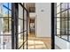 Entryway with open black-framed glass door, hardwood floors, and a staircase at 247 Huntington Ne Rd, Atlanta, GA 30309