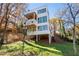 Modern white house on stilts with large windows and a wooded hillside at 247 Huntington Ne Rd, Atlanta, GA 30309