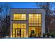 Modern home with illuminated windows and a brick exterior at twilight at 247 Huntington Ne Rd, Atlanta, GA 30309