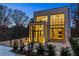 Modern home exterior with large windows and brick facade at twilight at 247 Huntington Ne Rd, Atlanta, GA 30309