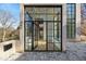 Modern black-framed glass front door of a brick home, showing the entryway at 247 Huntington Ne Rd, Atlanta, GA 30309