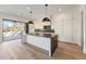 Kitchen with white cabinets, marble countertops, island, and sliding doors to patio at 247 Huntington Ne Rd, Atlanta, GA 30309