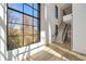 Bright living room with large windows, hardwood floors, and a staircase at 247 Huntington Ne Rd, Atlanta, GA 30309