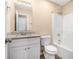 Clean bathroom with granite countertop, white vanity, and a tub shower combo at 2887 Rockcliff Se Rd, Atlanta, GA 30316