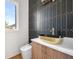 Stylish powder room with dark patterned tile and gold sink at 2251 Old Atlanta Rd, Cumming, GA 30041