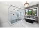 Luxurious bathroom with soaking tub, large walk-in shower, and marble floors at 2251 Old Atlanta Rd, Cumming, GA 30041